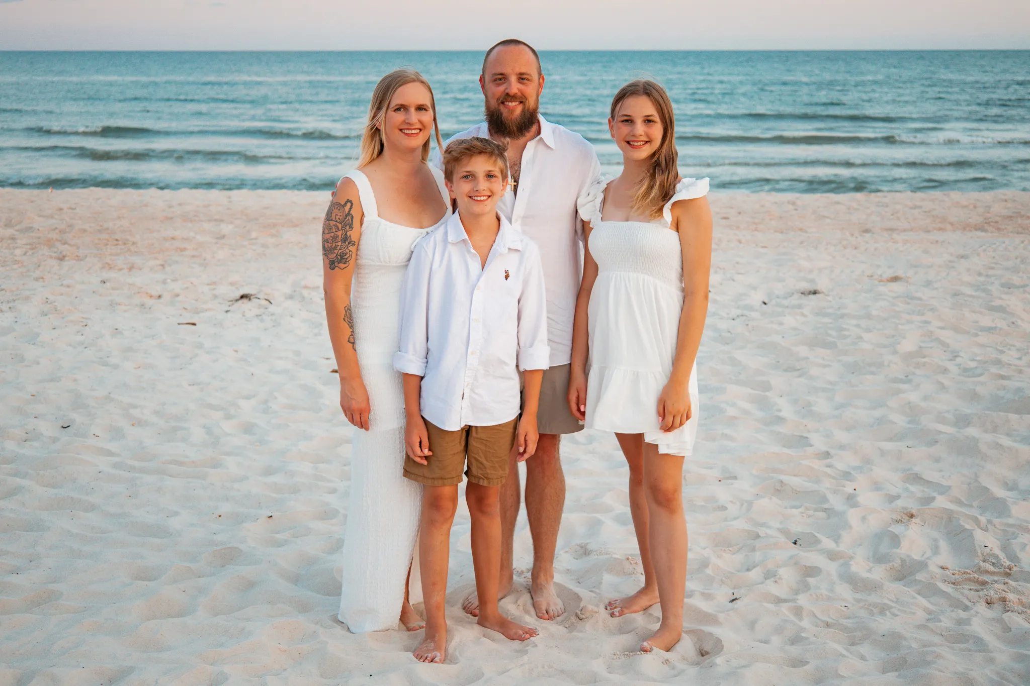 Family standing on a beach