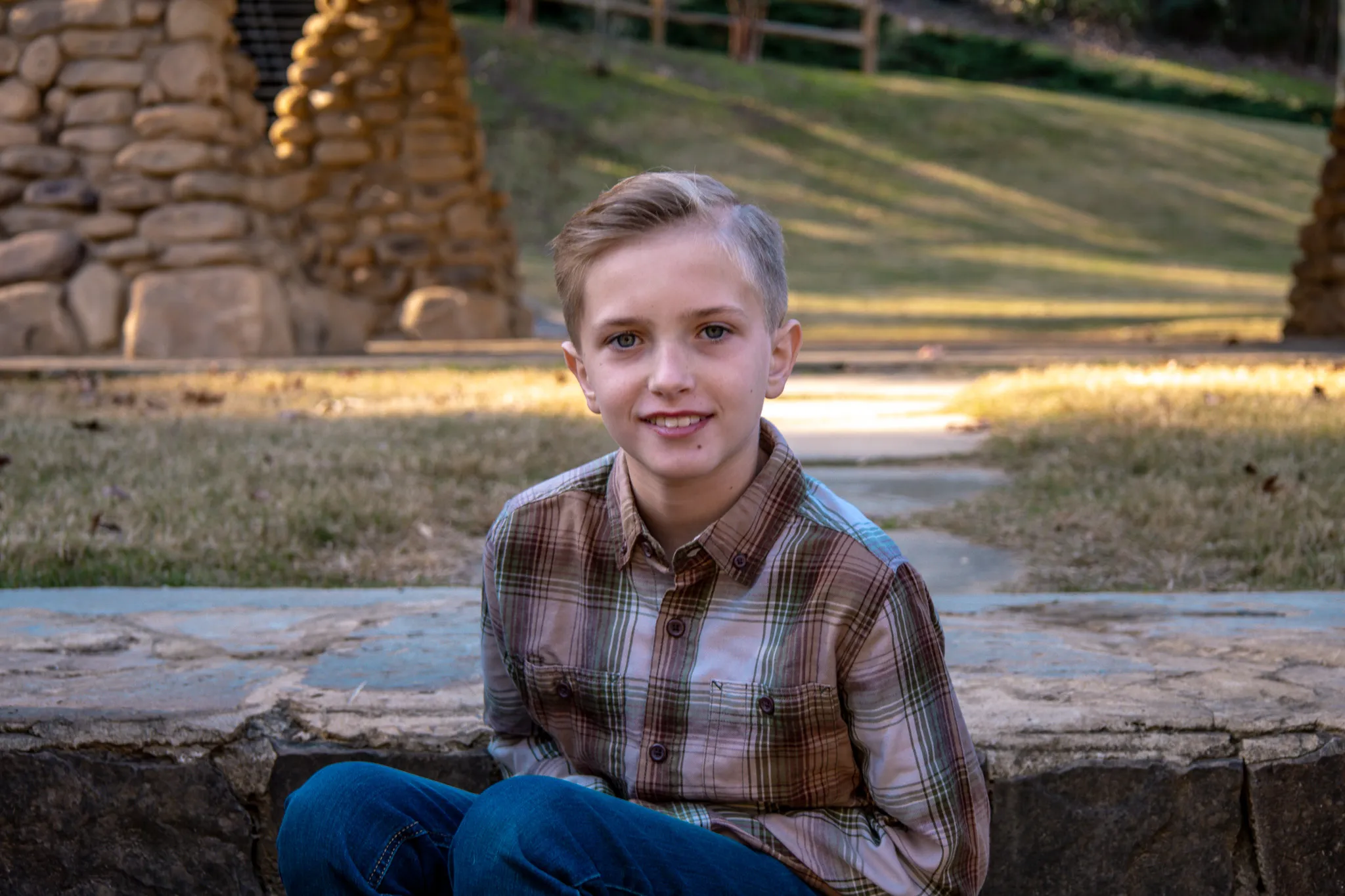 Boy smiling at camera sitting on step