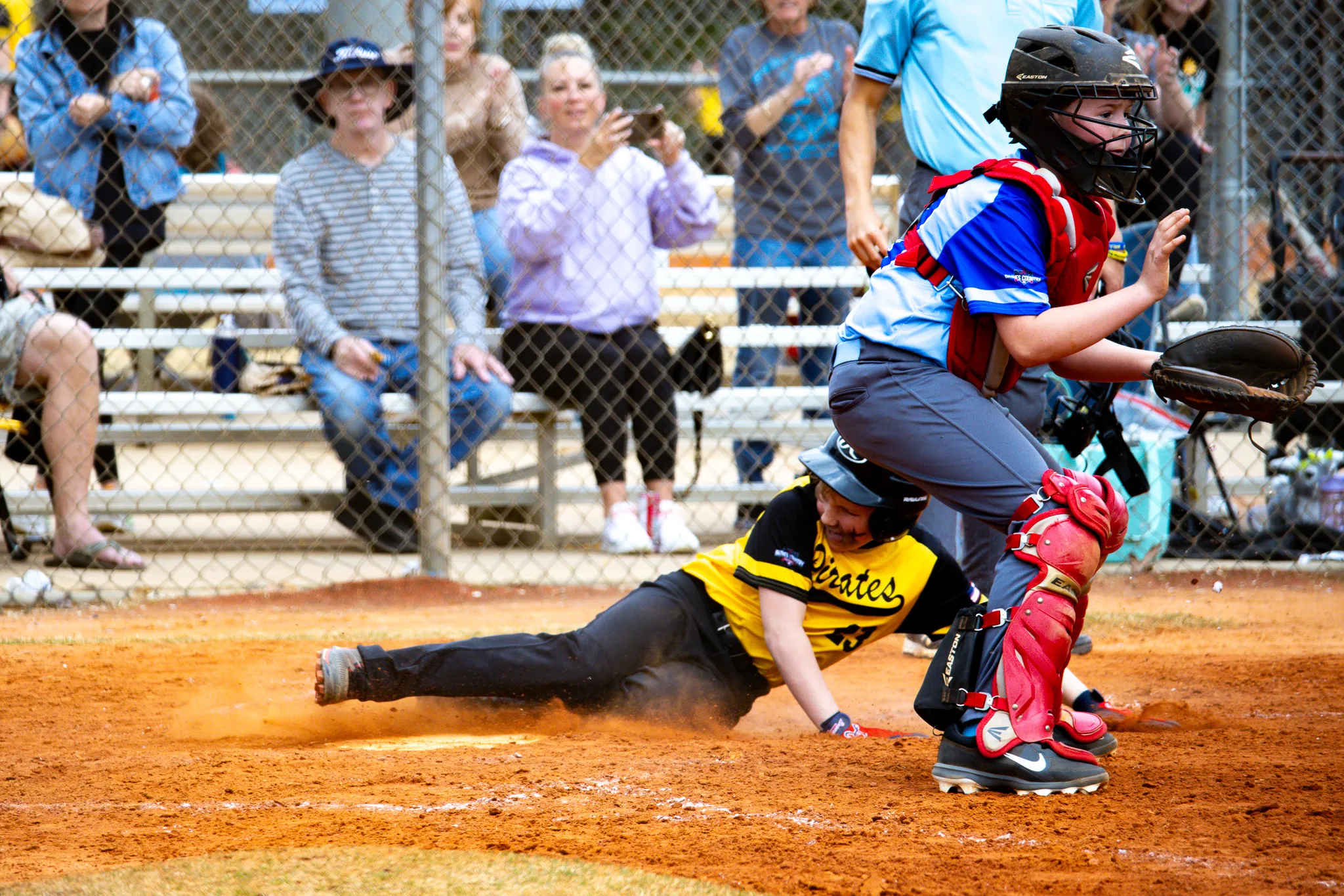 Baseball player sliding into home plate
