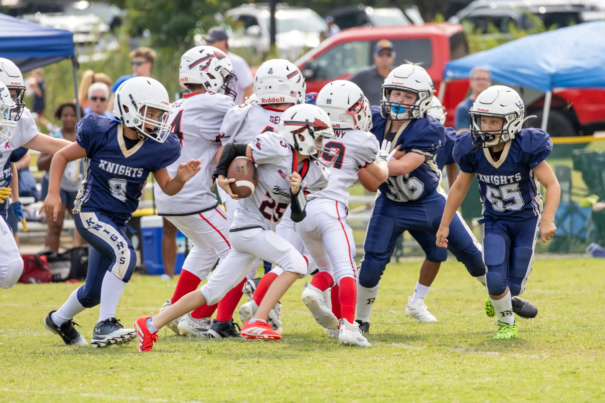 Football player running with the football past the defensive line